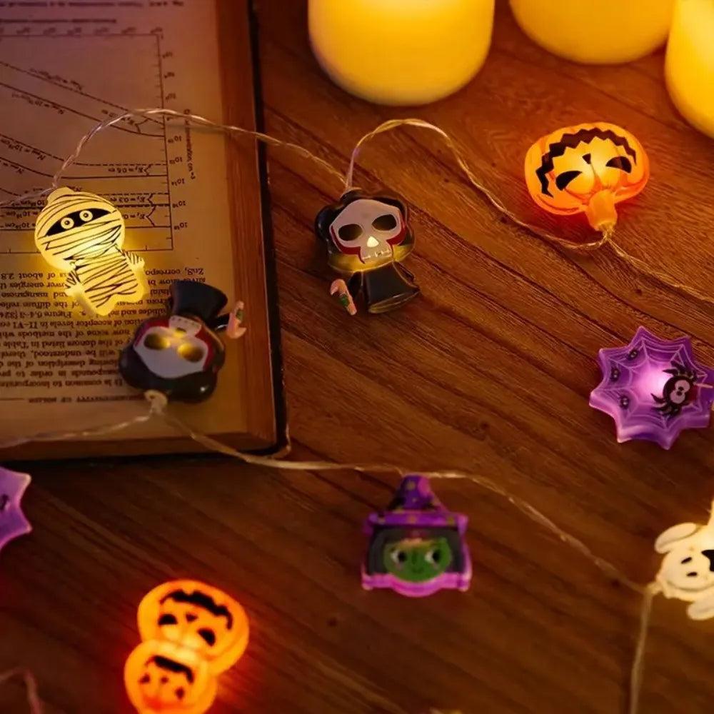 String lights featuring various Halloween motifs like skulls and pumpkins illuminating a wooden surface.