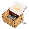 A vintage hand-cranked wooden music box with a light wood casing and a lid featuring the text You are sunshine.