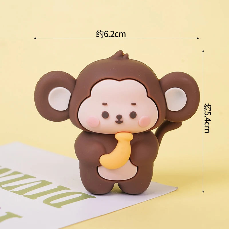 A set of brown animal cake toppers resembling a cute monkey with large ears and a yellow accent.