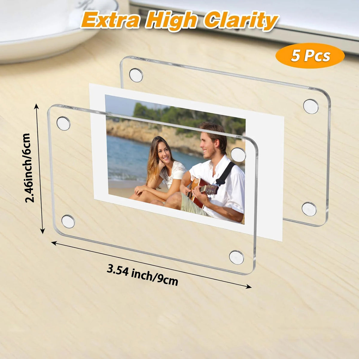 Five clear acrylic magnetic fridge frames with printed photos are shown on a wooden surface.