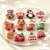 Assorted Christmas resin cabochons featuring teddy bears, Santa figures, and festive decorations arranged in a clear dish.