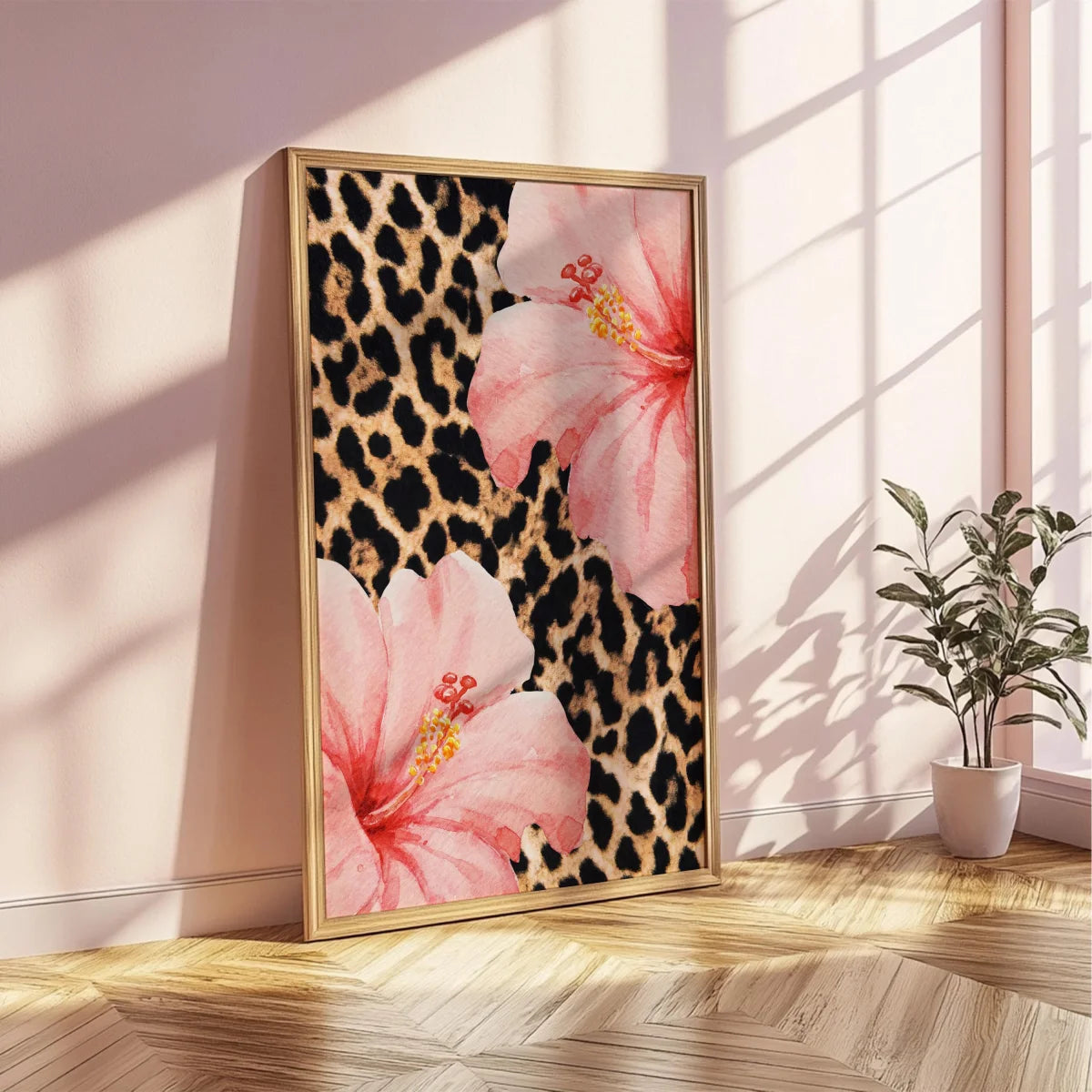 Pink leopard hibiscus canvas wall art framed in gold on a light pink wall