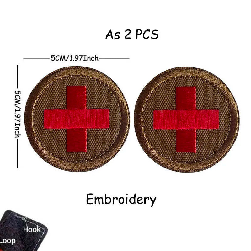 Two brown embroidered medical cross tactical morale patches with a red cross design and a hook loop.