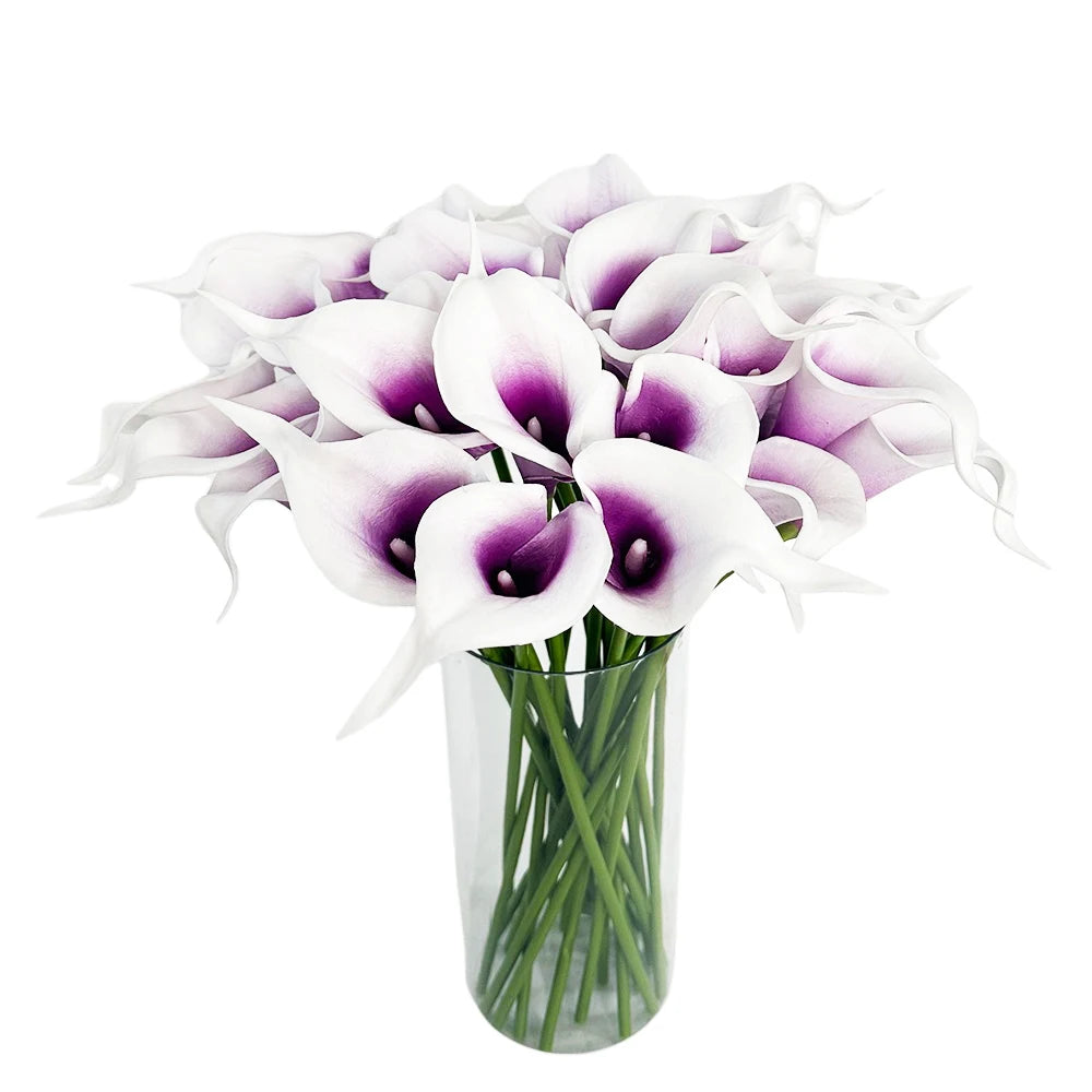 A bouquet of six artificial calla lilies with white and purple markings in a clear glass vase.