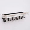 A rustic wooden floating shelf with hooks featuring distressed white and natural wood planks.