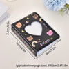 A black mini photo card album binder with a heart-shaped clear window decorated with pastel animals and rainbows.