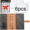 A set of six clear plastic stickers with text and a red ribbon on an orange leather planner binder.