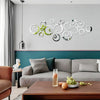 A modern living room wall decorated with a set of geometric hollow circle mirror stickers on a light gray wall.