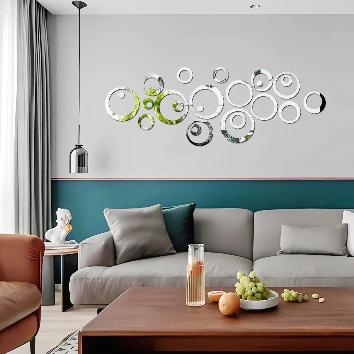 A modern living room wall decorated with a set of geometric hollow circle mirror stickers on a light gray wall.
