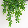 Green artificial ivy vine hanging down, used for home and garden decoration.