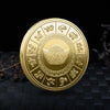 A round gold collectible coin featuring various mythical creatures and a central dragon design.