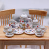 A 15-piece miniature porcelain tea set featuring a teapot and cups on a wooden table.
