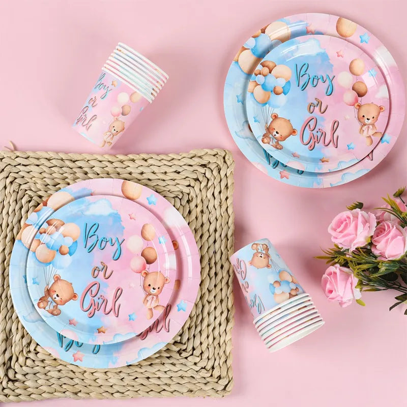 A set of light blue and pink plates and disposable cups for a gender reveal party.