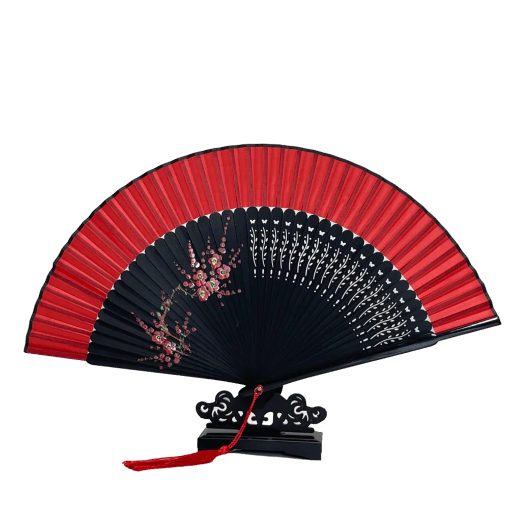 A red and black elegant bamboo folding fan with delicate floral designs shown open.