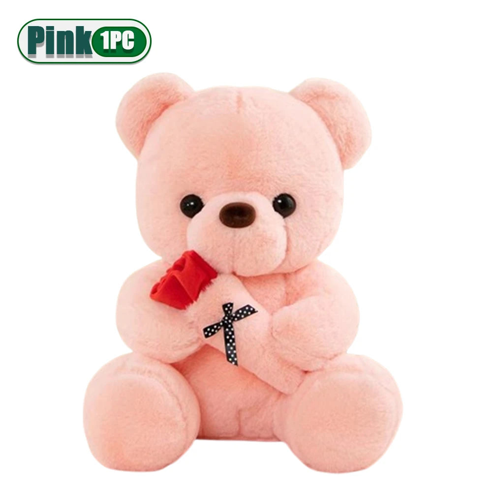 A pink teddy bear plush toy holding a red fabric flower