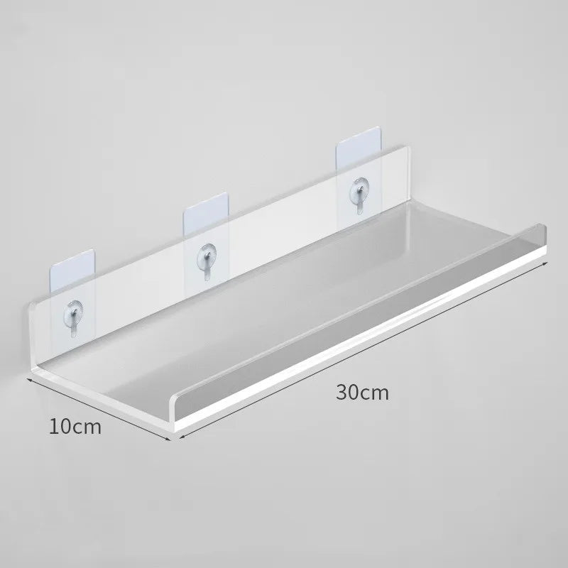 Clear acrylic floating shelf with wall mounts, measuring 30cm long and 10cm deep.