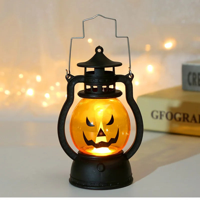 An orange Halloween LED pumpkin and ghost hanging lantern with a black frame and lid.