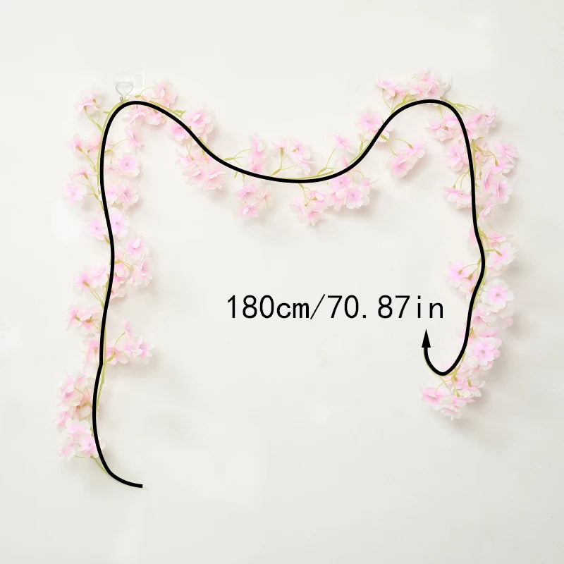 A black floral garland with pink sakura flowers is displayed against a white background.