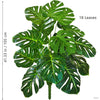 A vibrant artificial Monstera plant featuring 18 silk green leaves displayed against a white background.