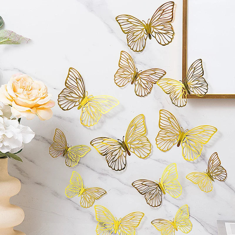 A set of three 3D gold butterfly wall decor pieces displayed on a white marble surface.