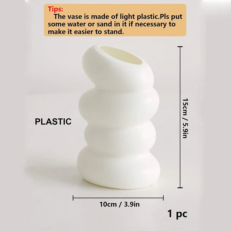 A white plastic Nordic spiral decorative vase with stacked, rounded sections.