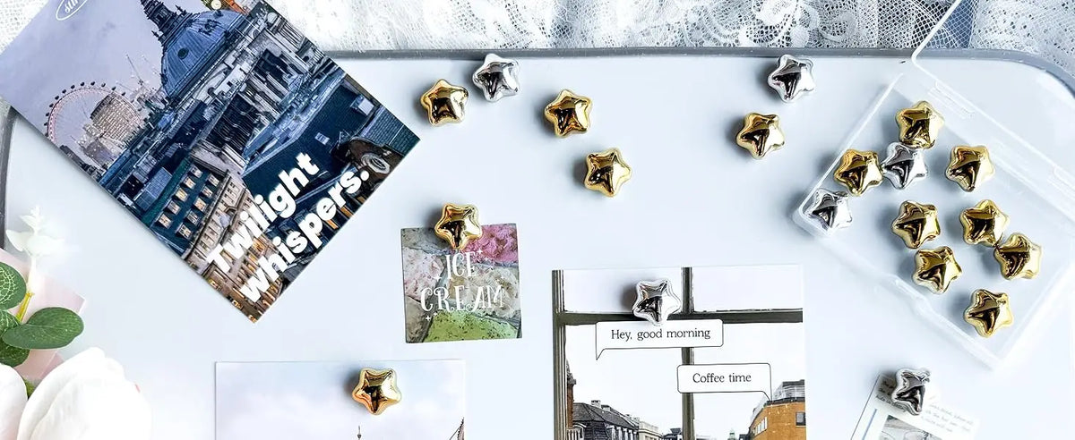 A collection of fifteen gold star-shaped fridge magnets arranged on a white surface.