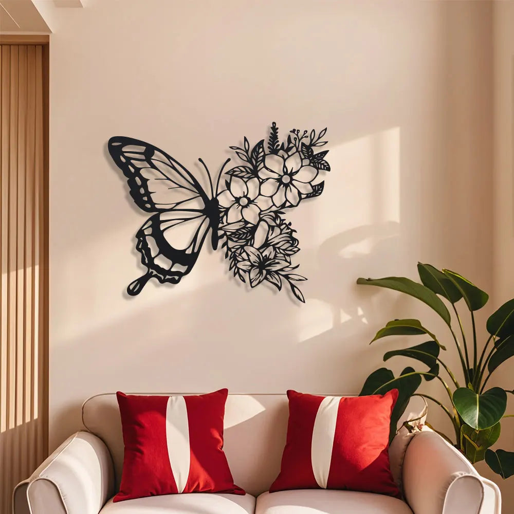 Black metal butterfly wall decor featuring an intricate floral pattern on a light-colored wall.