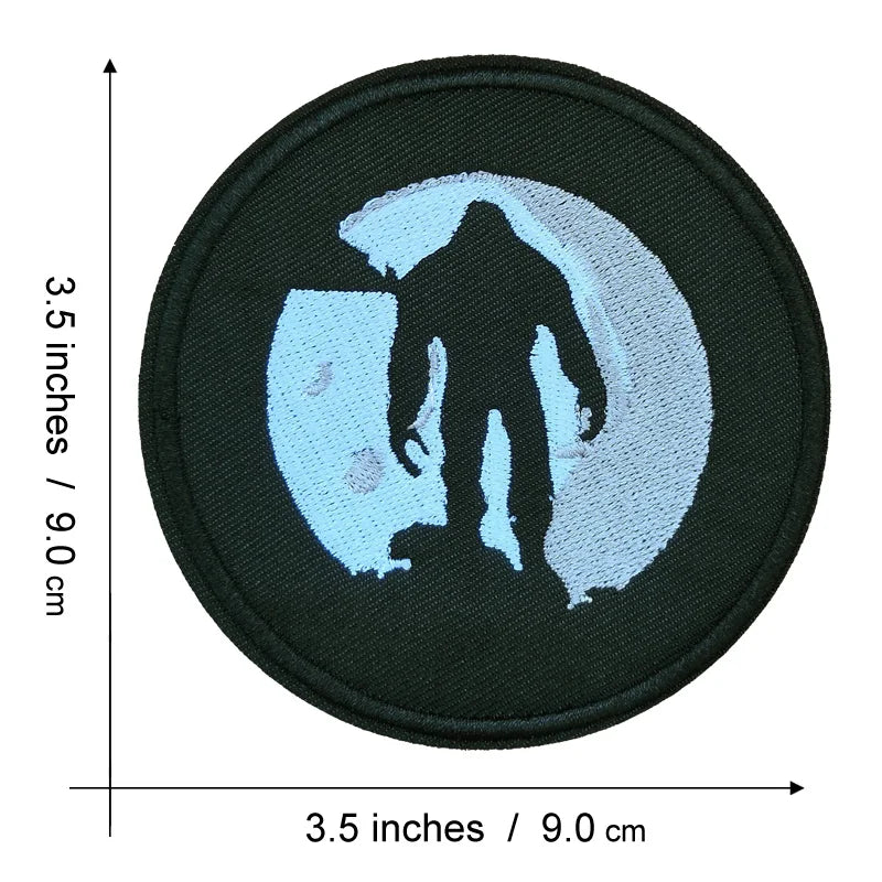 Black iron-on patch featuring a silhouette of Bigfoot in light blue embroidery.