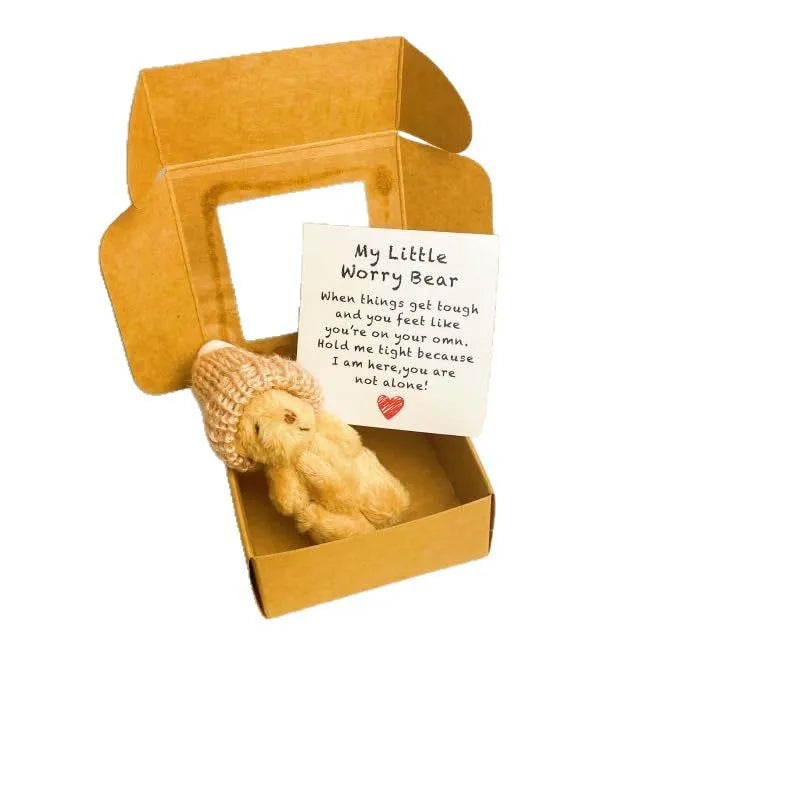 A plush worry bear with an encouraging card is displayed in a cardboard gift box.