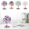 A collection of four crystal money tree decor plants in various shades of purple, green, and pink on a white background.