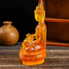 Handcrafted resin Medicine Buddha statue in orange-yellow color sitting in meditation pose