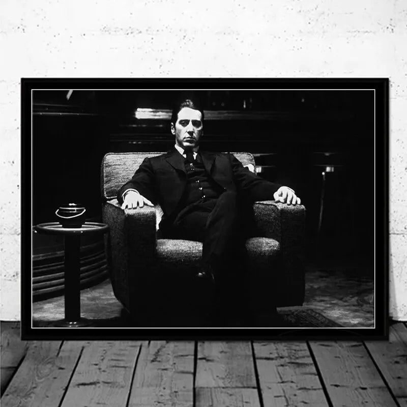Black and white portrait of a man in a suit sitting in an armchair, resembling a classic movie poster.