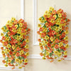 A vibrant hanging vine of orange and yellow flowers, resembling eucalyptus and violet pansies.