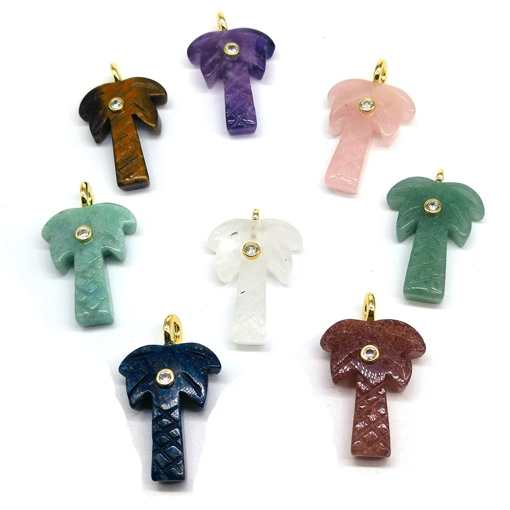 A collection of natural crystal pendants shaped like palm trees in various shades of purple, pink, green, and blue.