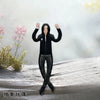 A black figure resembling Michael Jackson in a poseable outfit standing on a snowy surface.