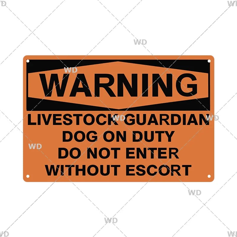 An orange metal warning sign with black text that reads WARNING LIVESTOCK GUARDIAN DOG ON DUTY DO NOT ENTER WITHOUT ESCORT