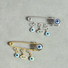 Elegant gold and silver evil eye brooch pin featuring multiple eye charms.
