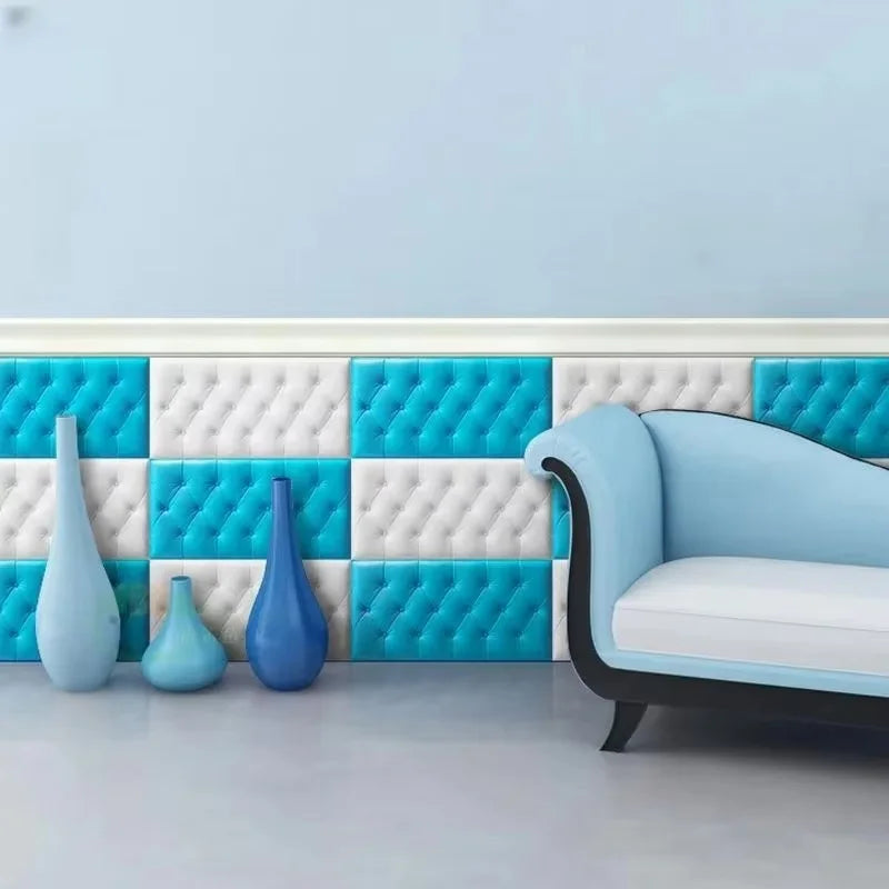 A light blue sofa is placed in front of a white and turquoise patterned wall with decorative skirting strips.