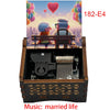 A wooden music box with a hand crank, featuring an illustration of a couple and the title Married Life.