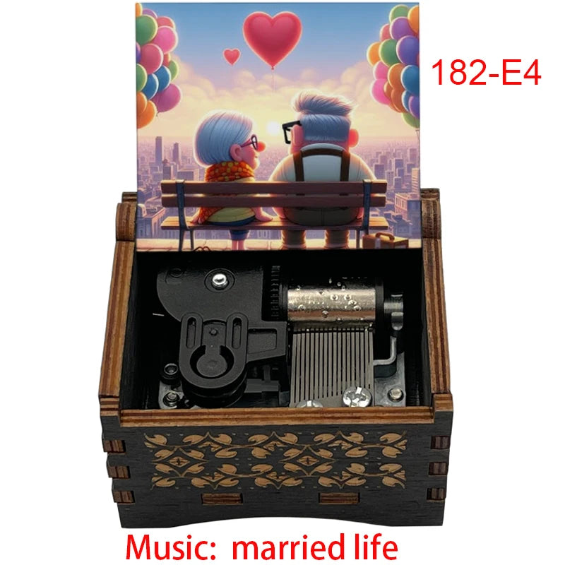 A wooden music box with a hand crank, featuring an illustration of a couple and the title Married Life.
