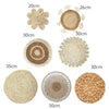 A collection of round boho straw wall hangings in various sizes and textures.