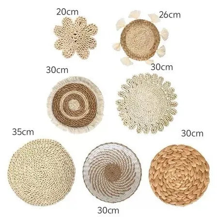 A collection of round boho straw wall hangings in various sizes and textures.