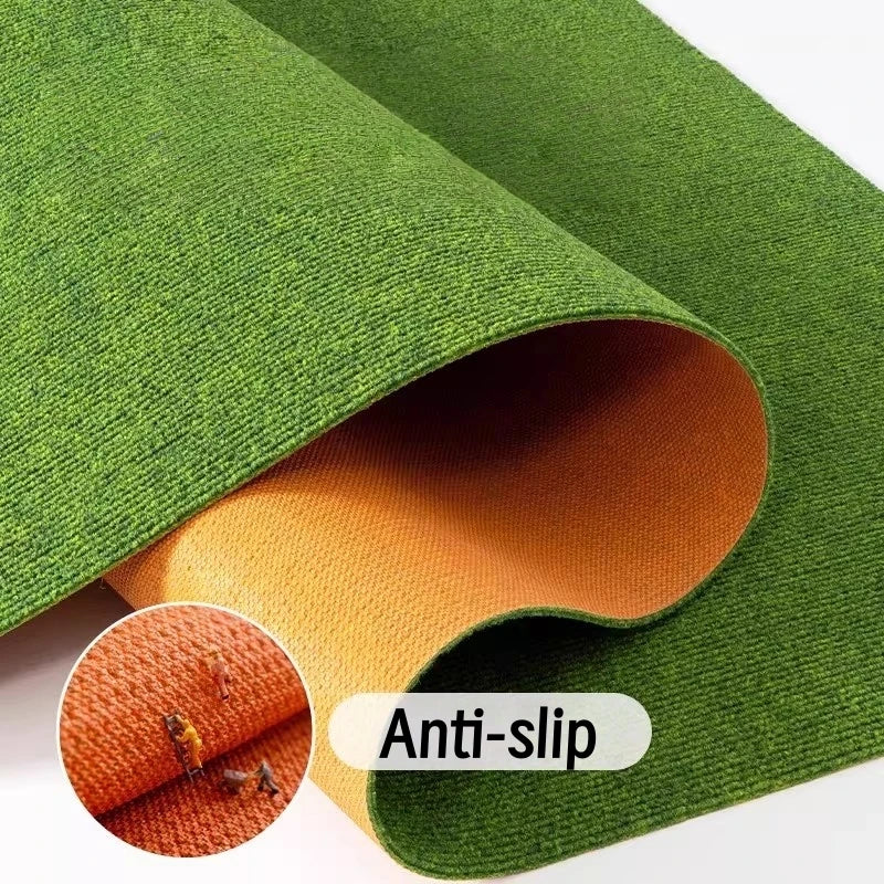 Roll of artificial green grass carpet showing an orange interior and anti-slip texture.