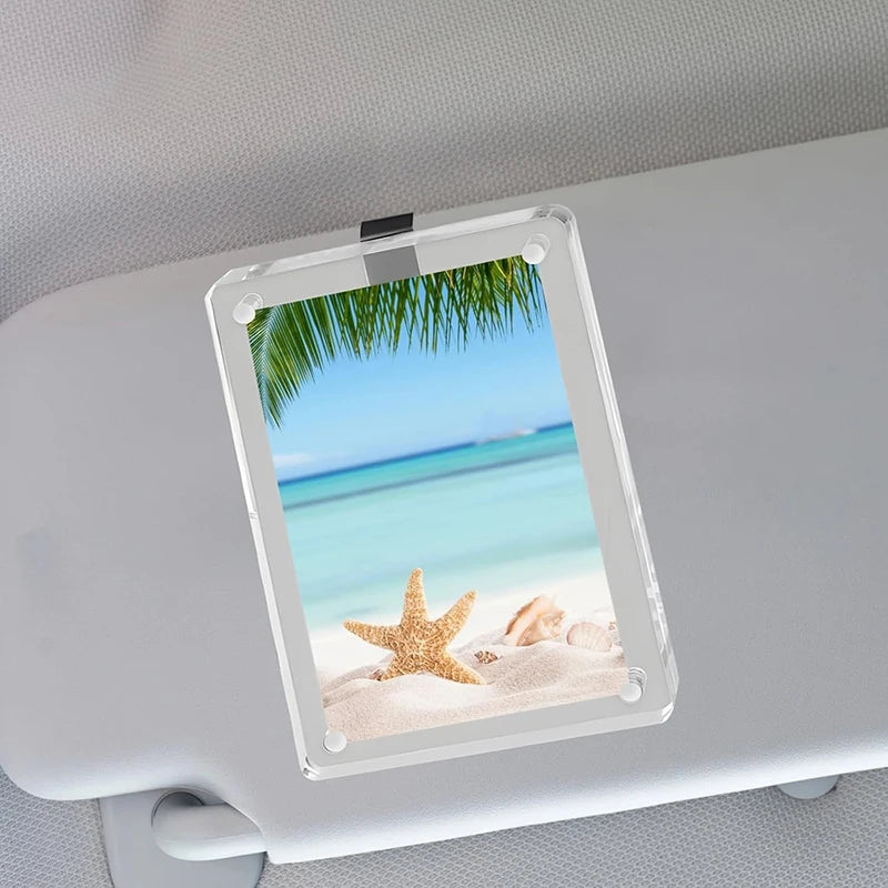 A clear photo clip featuring a tropical beach scene with palm fronds and starfish, mounted on a white surface.