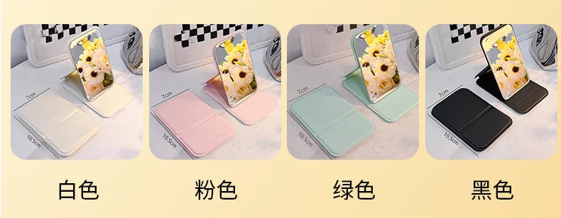 Four portable folding HD makeup mirrors in white, pink, green, and black colors displayed with floral accents.