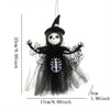A black witch ornament featuring a skull face and a skeletal design, suspended by a thin string.