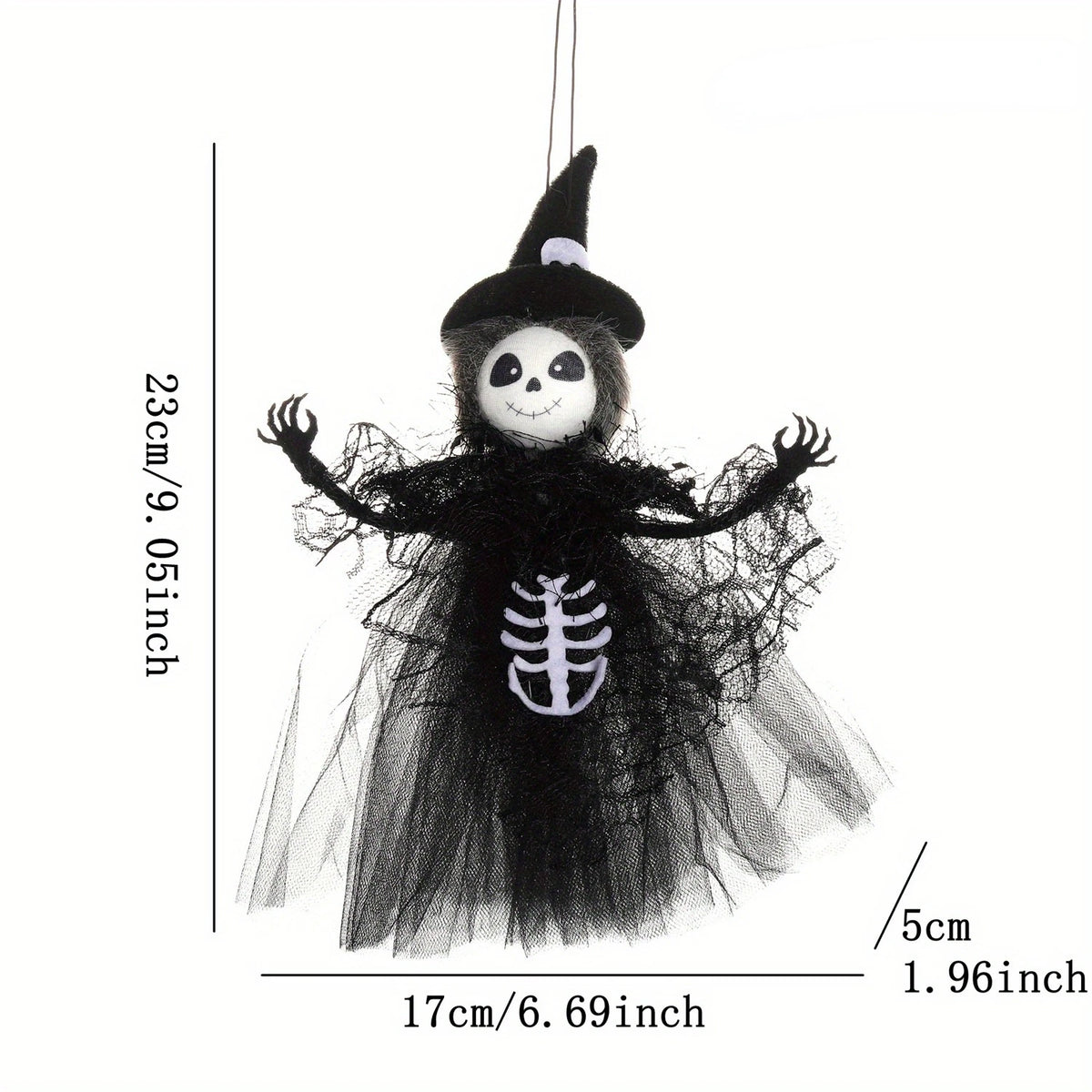A black witch ornament featuring a skull face and a skeletal design, suspended by a thin string.