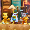 Three Digimon Adventure figures, including Tyrannosaurus and Triceratops, displayed on a surface.