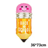 Pinkes Pappballon in Form eines Schulhauses mit der Aufschrift BACK TO SCHOOL