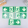 A set of five photoluminescent emergency exit sign decals showing various directional arrows.